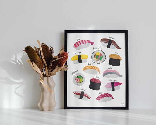 Sushi print with black frame on white table and fall foliage
